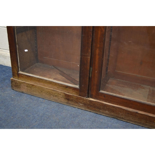 1230 - A LARGE DISTRESSED VICTORIAN MAHOGANY TRIPLE DOOR ASTRAGAL GLAZED BOOKCASE, with fourteen adjustable... 