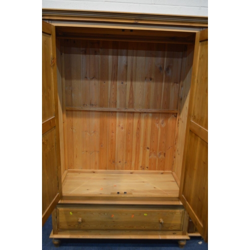 1236 - A PINE DOUBLE DOOR WARDROBE, flanked with barley twist rope detail, above a single long drawer, widt... 