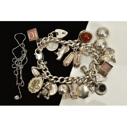 124 - A SILVER CHARM BRACELET AND CHAIN, the charm bracelet suspending twenty six charms such as a church,... 