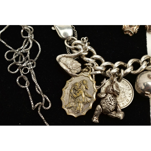 124 - A SILVER CHARM BRACELET AND CHAIN, the charm bracelet suspending twenty six charms such as a church,... 