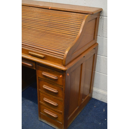 1244 - AN EARLY TO MID 20TH CENTURY GOLDEN OAK ROLL TOP DESK, fitted interior (one drawer dismantled) above... 