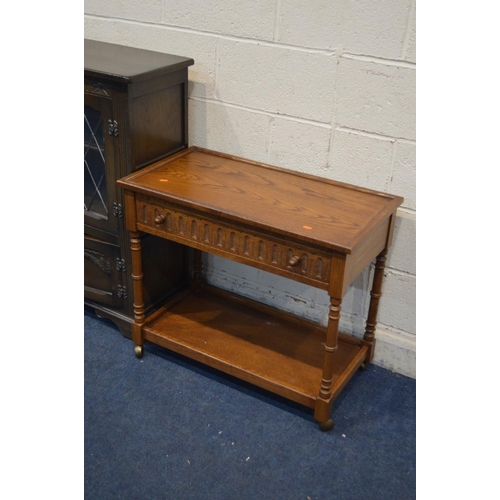 1258 - AN OAK LEAD GLAZED TWO DOOR BOOKCASE, together with an oak tea trolley with a single drawer and oak ... 