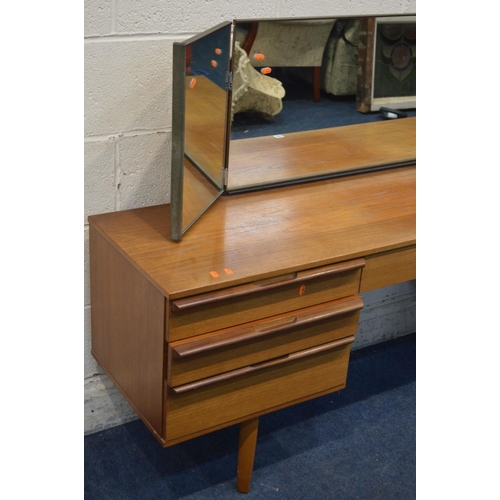 1264 - A MID TWENTIETH CENTURY TEAK DRESSING TABLE, with a triple dressing mirror and seven drawers, width ... 