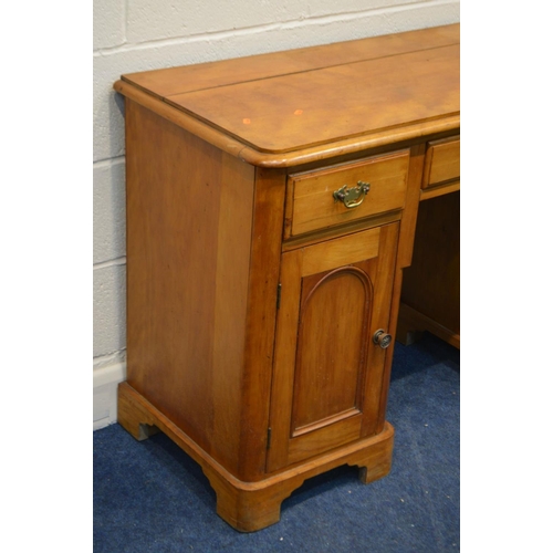 1268 - A VICTORIAN SATINWOOD KNEE HOLE DESK, with three drawers over two pedestal panelled cupboard doors, ... 