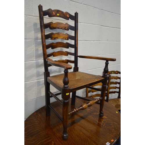 1294 - AN EARLY TO MID 20TH CENTURY OAK OVAL TOPPED GATE LEG TABLE, together with a set of five rush seated... 