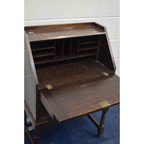 1297 - A MID TO LATE 20TH CENTURY OAK BUREAU, with two short over one long drawer, width 67cm x depth 38cm ... 