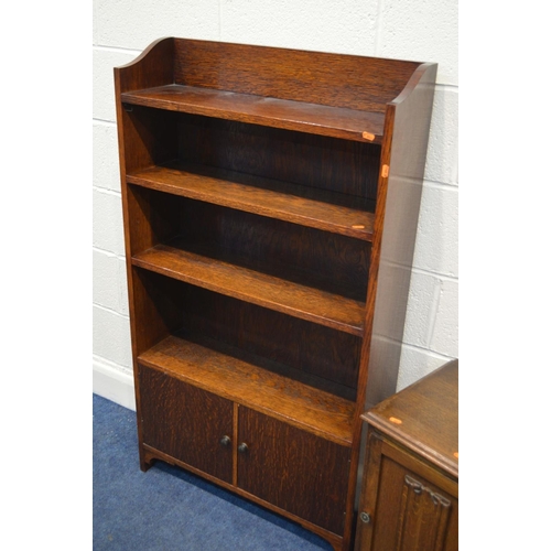 1299 - AN EARLY TO MID 20TH CENTURY OAK OPEN BOOKCASE with three fixed shelves under a double door cupboard... 