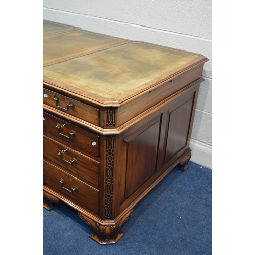 1310 - A REPRODUCTION MAHOGANY PARTNERS DESK, the top with canted corners above fretwork decoration, invert... 