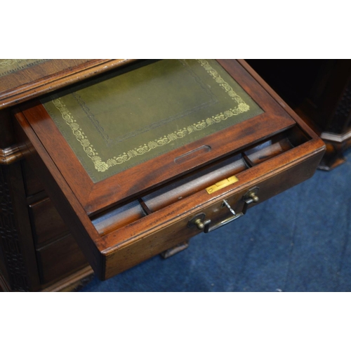 1310 - A REPRODUCTION MAHOGANY PARTNERS DESK, the top with canted corners above fretwork decoration, invert... 