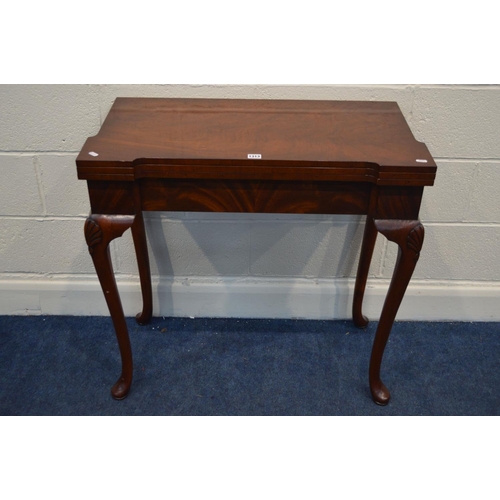 1313 - A REPRODUCTION MAHOGANY CONCERNTINA CARD TABLE, double fold over top enclosing an olive green leathe... 