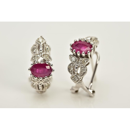 133 - A MODERN PAIR OF FANCY RUBY AND DIAMOND STUD EARRINGS, fitting to an Omega post fitting, estimated m... 