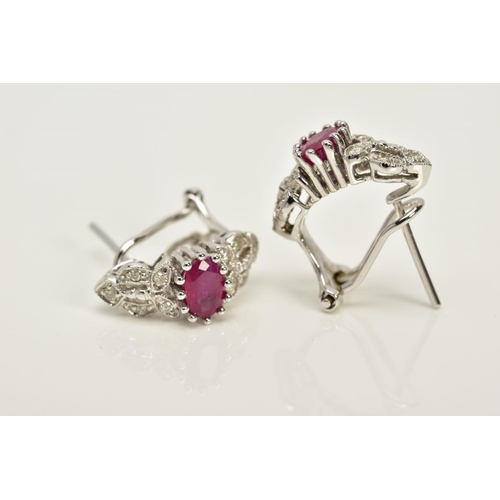 133 - A MODERN PAIR OF FANCY RUBY AND DIAMOND STUD EARRINGS, fitting to an Omega post fitting, estimated m... 