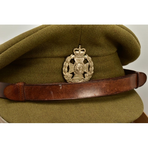 152 - A HAT BOX CONTAINING TWO MILITARY OFFICERS CAPS, a WWI era drab Olive colour peaked cap, silver colo... 