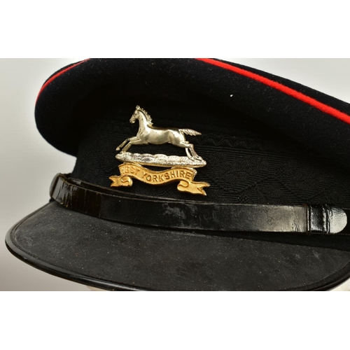 152 - A HAT BOX CONTAINING TWO MILITARY OFFICERS CAPS, a WWI era drab Olive colour peaked cap, silver colo... 