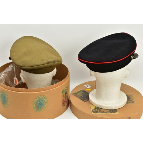 152 - A HAT BOX CONTAINING TWO MILITARY OFFICERS CAPS, a WWI era drab Olive colour peaked cap, silver colo... 