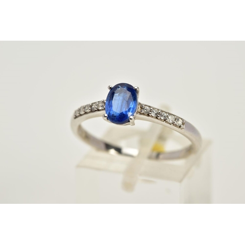 16 - A 9CT WHITE GOLD RING, designed with a claw set oval blue stone, assessed as Kyanite, circular cut c... 