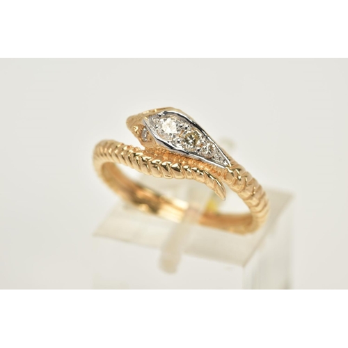 20 - A YELLOW METAL OUROBOUS RING, the snakes head and eyes set with round brilliant cut diamonds, to a t... 