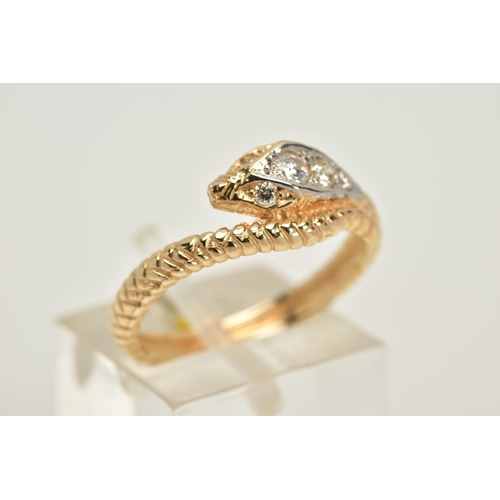 20 - A YELLOW METAL OUROBOUS RING, the snakes head and eyes set with round brilliant cut diamonds, to a t... 