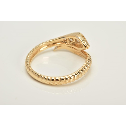 20 - A YELLOW METAL OUROBOUS RING, the snakes head and eyes set with round brilliant cut diamonds, to a t... 