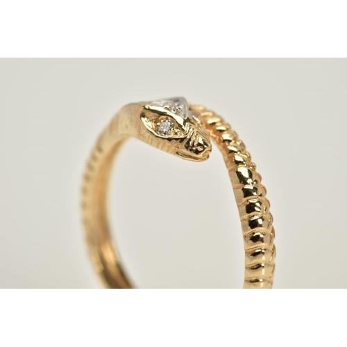 20 - A YELLOW METAL OUROBOUS RING, the snakes head and eyes set with round brilliant cut diamonds, to a t... 