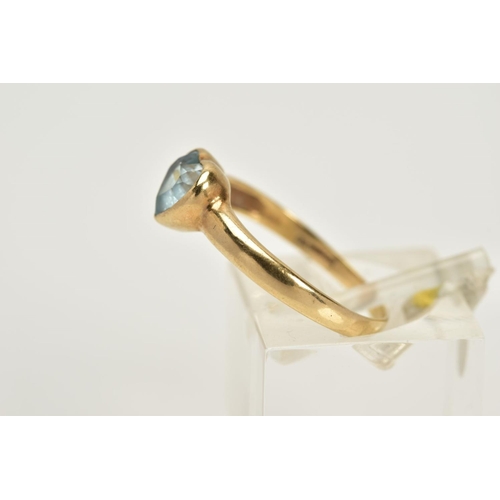 22 - A 9CT GOLD TOPAZ RING, designed with a heart cut blue topaz within a collet mount, plain polished ba... 