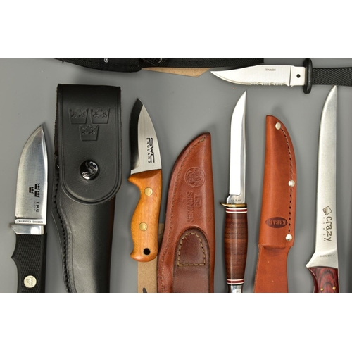 275 - A NUMBER OF SHEATH KNIVES EACH WITH A HOLSTER comprising of Crazy River, two x Elk Ridge, Lakota, TK... 