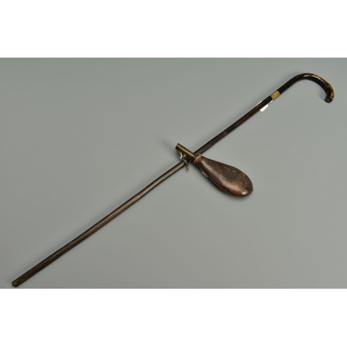 294 - AN ANTIQUE BAMBOO SWORD STICK, in the form of a round handled walking stick, the blade is six sided ... 