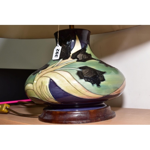 392 - A MOORCROFT POTTERY SQUAT SHAPED TABLE LAMP, 'Black Tulip' pattern, on a wooden plinth, height not i... 