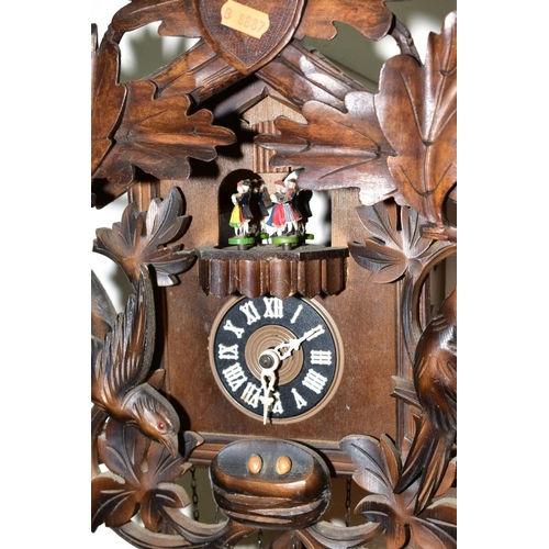 401 - A MID TWENTIETH CENTURY BLACK FOREST STYLE CUCKOO CLOCK, with matched pediment and pendulum, with da... 