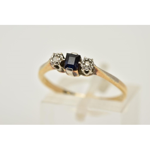 46 - A YELLOW METAL SAPPHIRE AND DIAMOND RING, designed with a central rectangular cut sapphire, flanked ... 