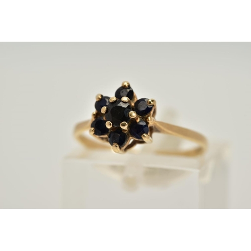 48 - A 9CT GOLD SAPPHIRE CLUSTER RING, the tiered cluster set with circular cut blue sapphires, tapered s... 