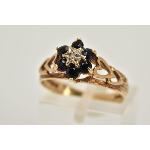 50 - A 9CT GOLD SAPPHIRE AND DIAMOND CLUSTER RING, designed with a star set single cut diamond centre, ci... 