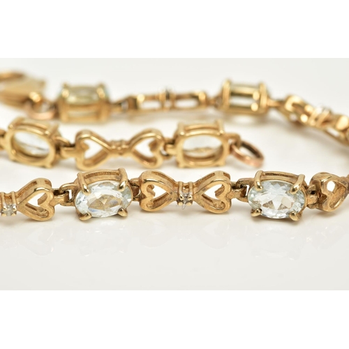 55 - A YELLOW METAL QUARTZ AND DIAMOND LINE BRACELET, designed with nine oval cut colourless quartz, inte... 