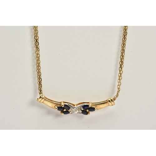 56 - A 9CT GOLD SAPPHIRE AND DIAMOND PENDANT NECKLACE, the fixed pendant panel designed with a central cr... 