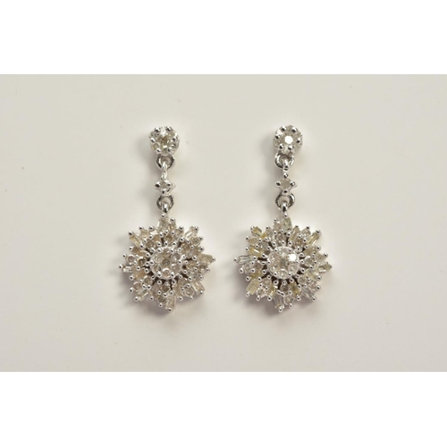 58 - A PAIR OF DIAMOND DROP EARRINGS, each white metal earring designed with a single cut diamond stud su... 