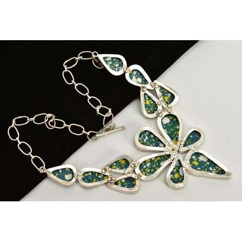 65 - A LARGE WHITE METAL ABSTRACT NECKLACE, designed with green, white and yellow enamel tear drop panels... 