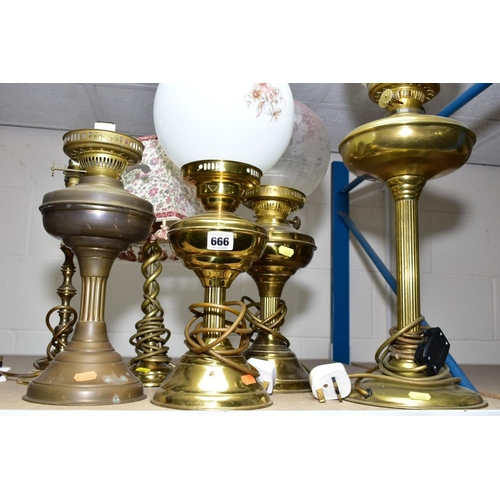 666 - A GROUP OF SIX BRASS TABLE LAMPS, including three converted to electric oil lamps, with glass shades... 