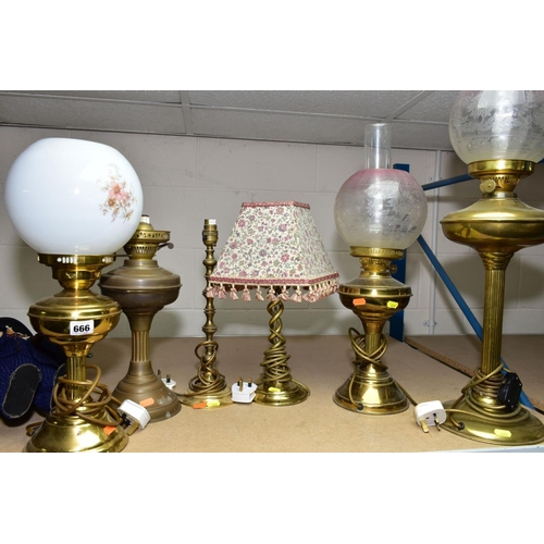 666 - A GROUP OF SIX BRASS TABLE LAMPS, including three converted to electric oil lamps, with glass shades... 