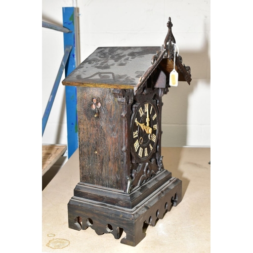 668 - A BLACK FOREST STYLE CUCKOO MANTLE CLOCK, having Roman numerals, standing 48cm high including finial... 