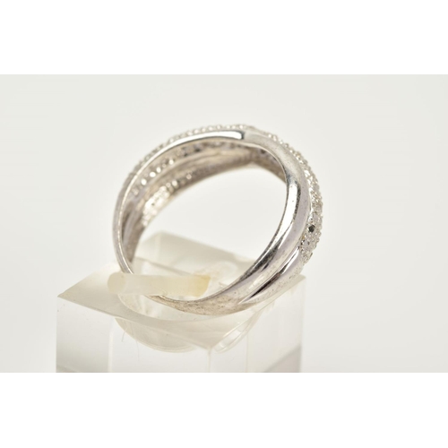 70 - A WHITE METAL DIAMOND RING, of crossover design, set with a row of single cut diamonds, plain polish... 