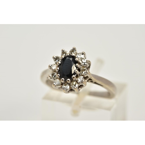 71 - AN 18CT WHITE GOLD SAPPHIRE AND DIAMOND CLUSTER RING, designed with a central oval cut sapphire with... 