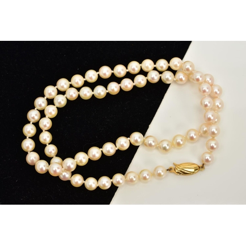 74 - A CULTURED PEARL STRAND NECKLACE, each pearl between approximately 6.0mm and 6.4mm, fitted to a yell... 