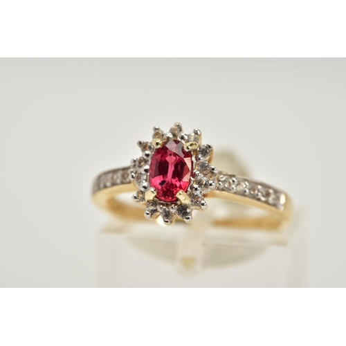 76 - A 9CT GOLD RUBY AND SAPPHIRE CLUSTER RING, designed with a central oval cut ruby within a circular c... 