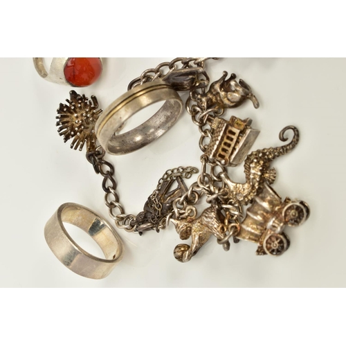 81 - A SELECTION OF JEWELLERY, to include a white metal charm bracelet, suspending nine charms such as a ... 