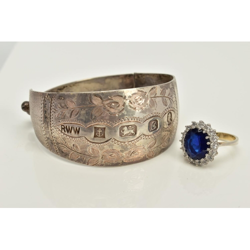 86 - A SILVER BANGLE AND RING, the silver hinged bangle with floral engraved detail, hallmarked Birmingha... 