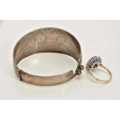 86 - A SILVER BANGLE AND RING, the silver hinged bangle with floral engraved detail, hallmarked Birmingha... 