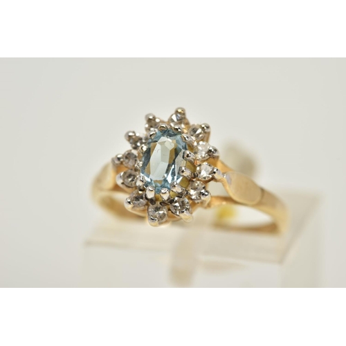 9 - A 9CT GOLD AQUAMARINE AND DIAMOND CLUSTER RING, set with a central oval cut aquamarine within a sing... 