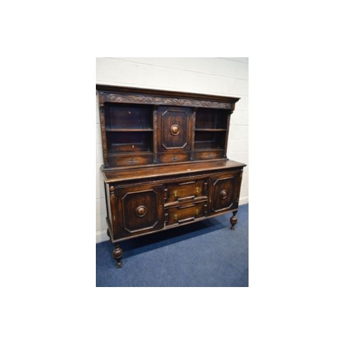 1356 - AN EARLY 20TH CENTURY OAK DRESSER, the top section with two open shelves flanking a single cupboard ... 