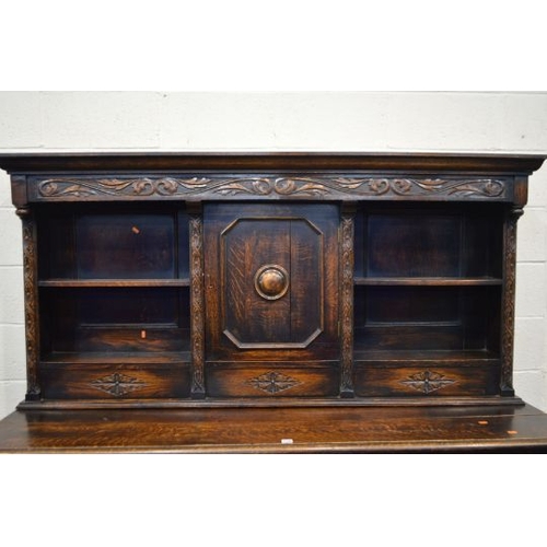 1356 - AN EARLY 20TH CENTURY OAK DRESSER, the top section with two open shelves flanking a single cupboard ... 