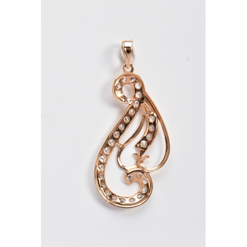 10 - A YELLOW METAL OPENWORK PENDANT, of scroll design, embellished with circular cut cubic zirconia, sta... 